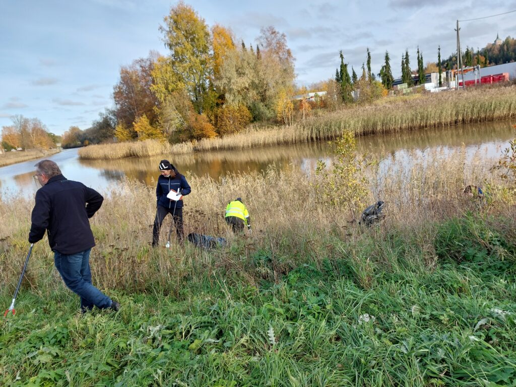 Ihmisiä siistimässä joen vartta