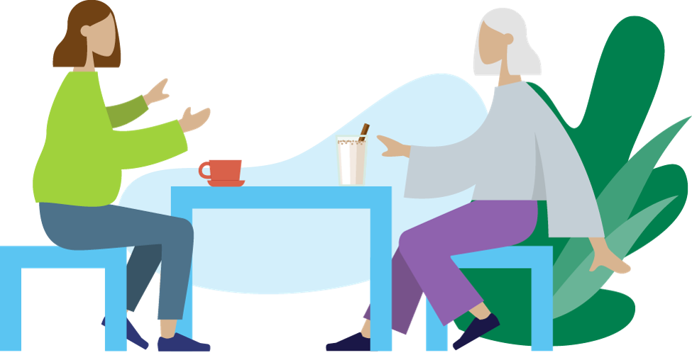 kaksi henkilöä pöydän ääressä keskustelemassa  